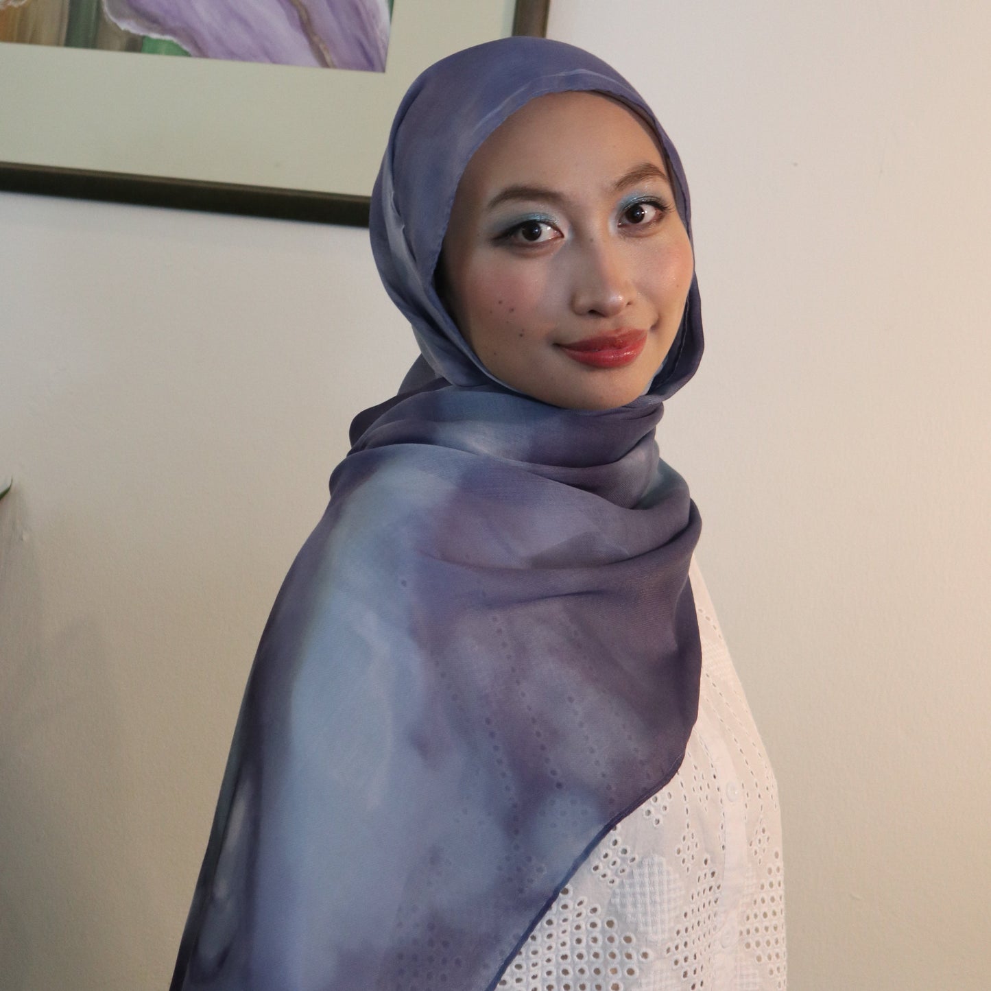 Woman wearing blue tie dye inspired hijab made from eco certified fabric
